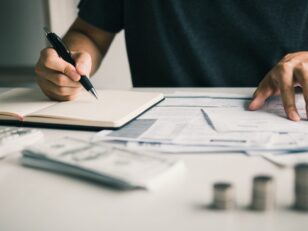 Man use calculators and documents that calculate expenses in the