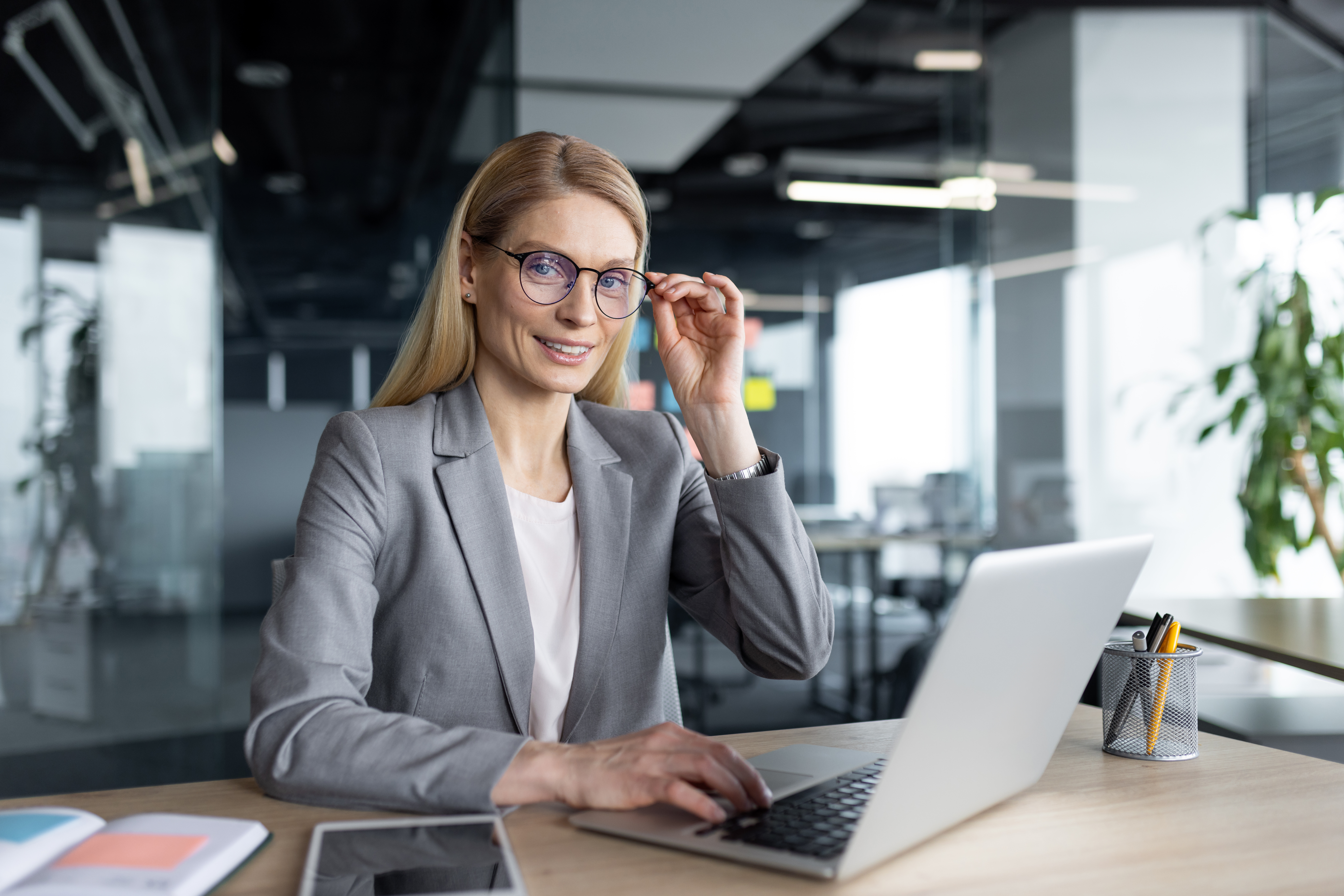Professional woman in a modern office working on her laptop computer